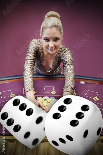 Photo: Blonde woman grabbing chips with digital dice Blonde woman grabbing chips with digital dice