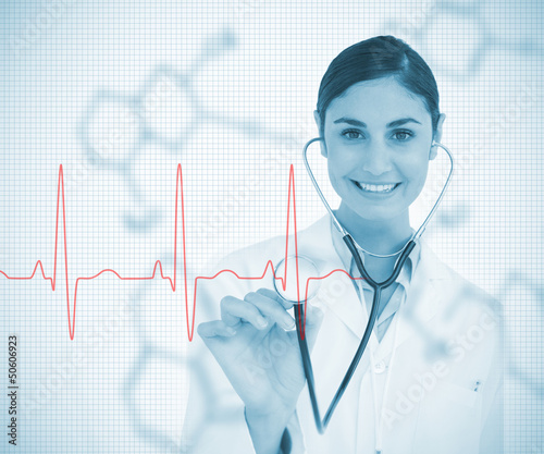 Photo: Doctor holding stethoscope up to red ECG line Doctor holding stethoscope up to red ECG line