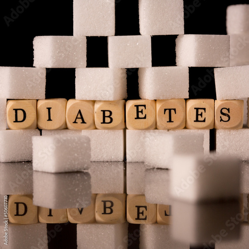 Photo: Close up on sugar cubes and dice spelling diabetes Close up on sugar cubes and dice spelling diabetes
