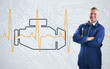 Mechanic standing proudly in front of engine background