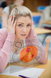 Blonde woman thinking hard while studying on futuristic interfac