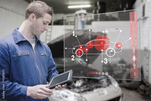 Photo: Mechanic using tablet and futuristic interface Mechanic using tablet and futuristic interface
