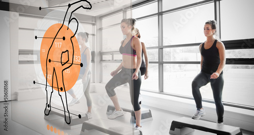 Photo: Women workout with futuristic interface showing them how to do Women workout with futuristic interface showing them how to do