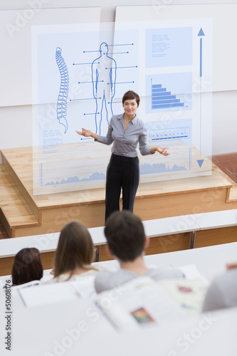 Photo: Teacher in front of futuristic interface asking a question Teacher in front of futuristic interface asking a question