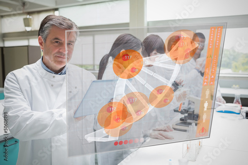 Photo: Confident scientist working with tablet and futuristic interface Confident scientist working with tablet and futuristic interface
