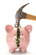 Piggy bank with money inside and hammer over