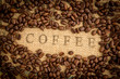 Coffee beans surrounding coffee stamp on sack