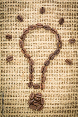 Photo: Light bulb made out of coffee beans with light beams Light bulb made out of coffee beans with light beams