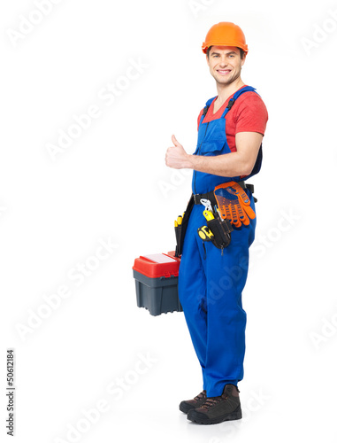 Photo: Handyman with tools showing the thumbs up sign Handyman with tools showing the thumbs up sign