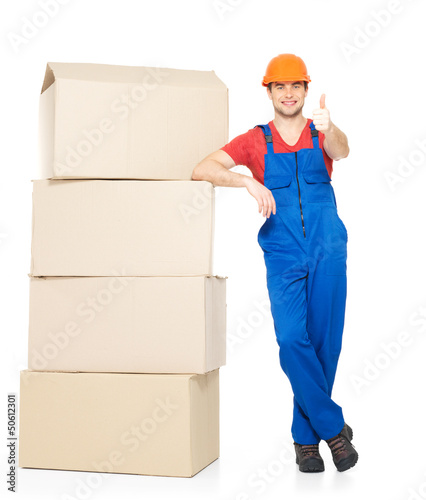 Photo: Delivery man with paper boxes and thumbs up sign Delivery man with paper boxes and thumbs up sign