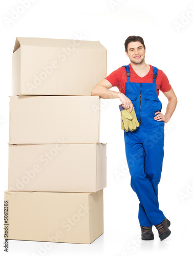 Photo: handsome young delivery man with paper boxes handsome young delivery man with paper boxes