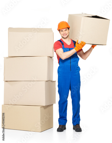 Photo: handsome young delivery man with paper boxes handsome young delivery man with paper boxes