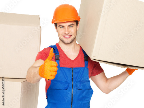 Photo: Delivery man with paper boxes and thumbs up sign Delivery man with paper boxes and thumbs up sign