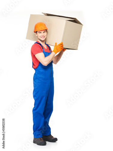 Photo: handsome young delivery man with paper boxes handsome young delivery man with paper boxes