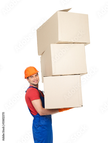 Photo: handsome young delivery man with paper boxes handsome young delivery man with paper boxes