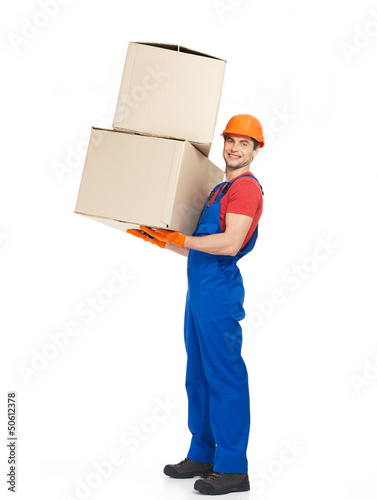 Photo: handsome young delivery man with paper boxes handsome young delivery man with paper boxes
