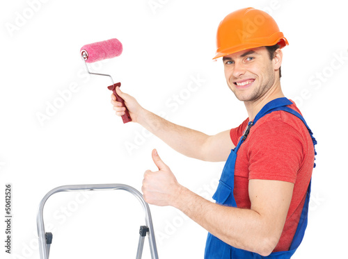 Photo: Craftsman painter stands on the stairs with roller Craftsman painter stands on the stairs with roller