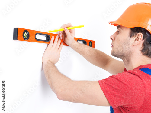 Photo: Construction worker measuring the level Construction worker measuring the level