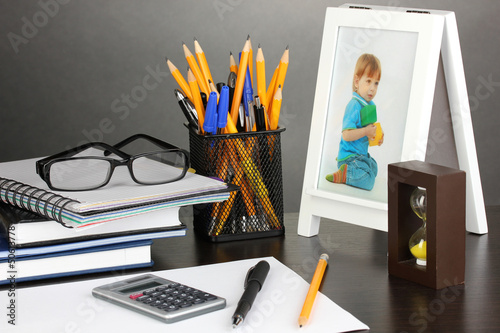 Photo: White photo frame on office desk on grey background White photo frame on office desk on grey background
