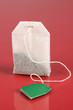 Tea bag on red background
