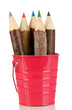 Colorful wooden pencils in pink purple green pail isolated