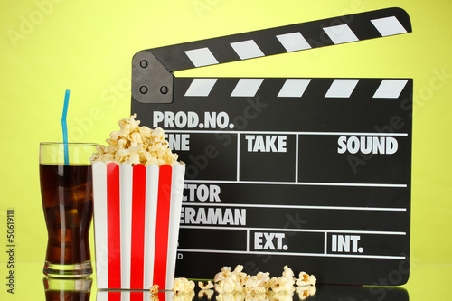 Photo: Movie clapperboard, cola and popcorn on background Movie clapperboard, cola and popcorn on background