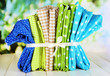 Color mottled fabrics on wooden table on natural background