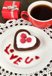 Chocolate cookie in form of heart with cup of coffee