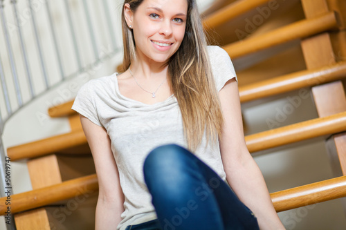 Photo: Young woman sitting on the stairs Young woman sitting on the stairs