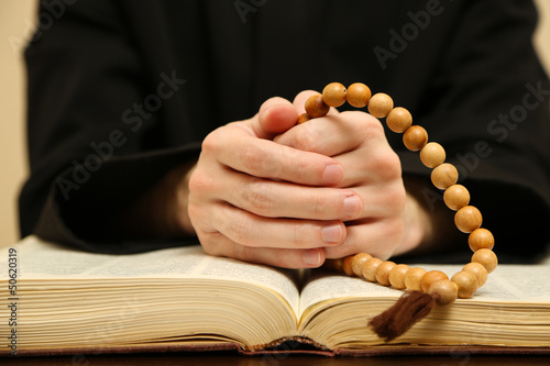 Photo: Priest reading from the holy bible, close up Priest reading from the holy bible, close up
