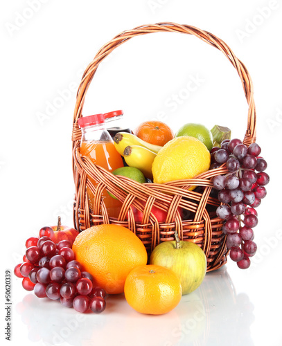 Photo: Different fruits in wicker basket with juice isolated on white Different fruits in wicker basket with juice isolated on white