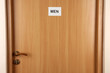 Toilet sign on wooden door