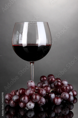Photo: Red wine glass on grey background Red wine glass on grey background