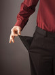 Businessman turning his empty pocket inside out