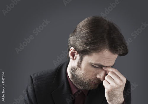 Photo: Forty years old depressed and overwhelmed businessman Forty years old depressed and overwhelmed businessman