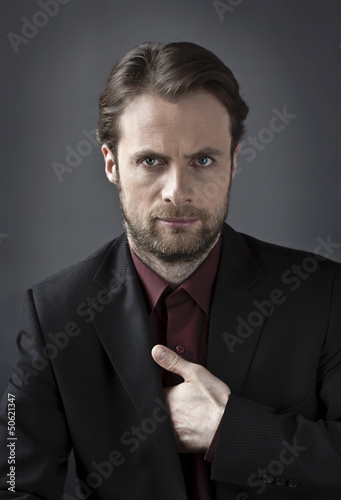 Photo: Serious man in a suit - secret agent or gangster concept Serious man in a suit - secret agent or gangster concept