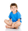 Portrait of young boy sitting isolated over a white background
