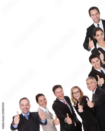 Photo: Group of executives giving a thumbs up Group of executives giving a thumbs up