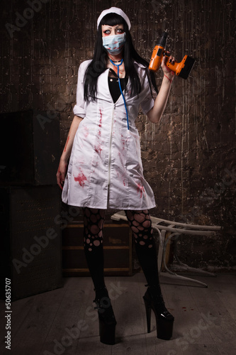 Photo: Crazy dead nurse with drill in the hand Crazy dead nurse with drill in the hand