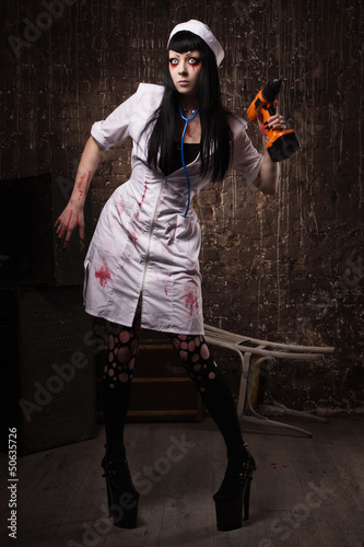 Photo: Crazy dead nurse with drill in the hand Crazy dead nurse with drill in the hand