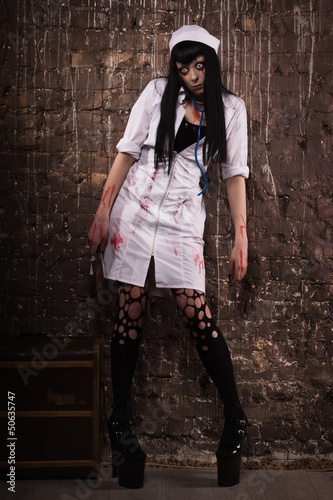 Photo: Crazy dead nurse with knife in the hand Crazy dead nurse with knife in the hand