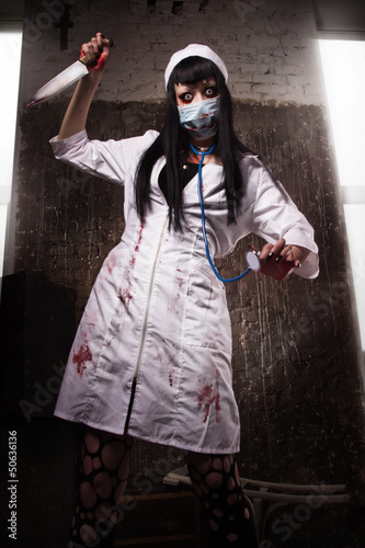 Photo: Crazy dead nurse with knife in the hand Crazy dead nurse with knife in the hand