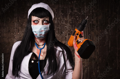 Photo: Crazy dead nurse with drill in the hand Crazy dead nurse with drill in the hand