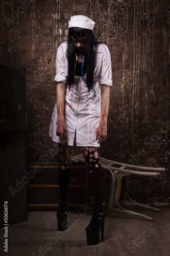 Photo: Crazy dead nurse with knife in the hand Crazy dead nurse with knife in the hand