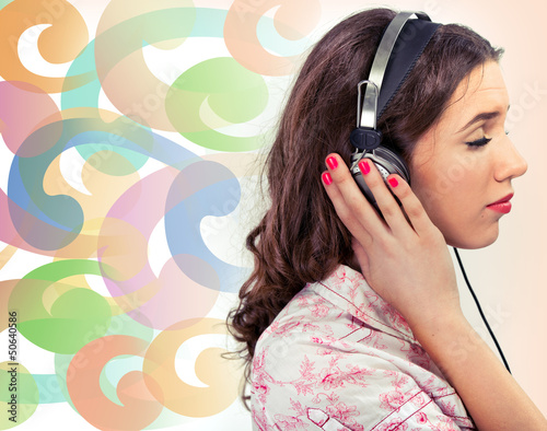 Photo: Woman with earphones over a colorful background Woman with earphones over a colorful background