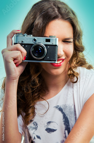 Photo: Woman with an old camera taking a photo Woman with an old camera taking a photo