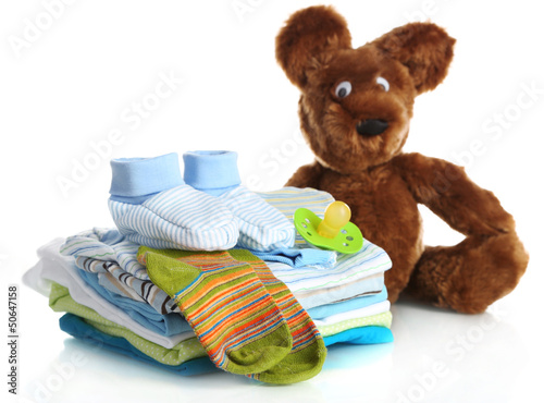 Photo: Pile of baby clothes isolated on white Pile of baby clothes isolated on white