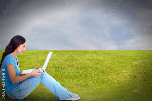 Photo: Young woman with laptop computer. Young woman with laptop computer.