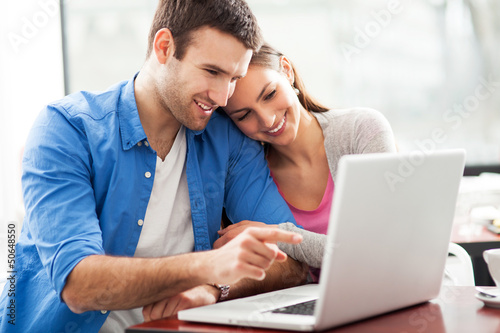Photo: Couple looking at laptop Couple looking at laptop