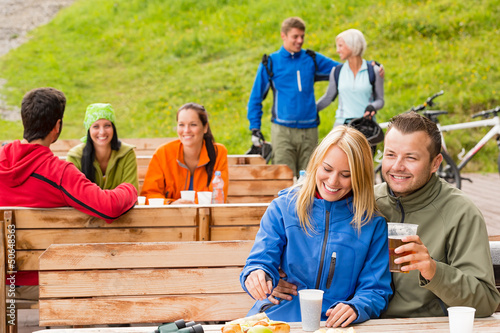 Photo: Friends having fun rest area drinking refreshments Friends having fun rest area drinking refreshments